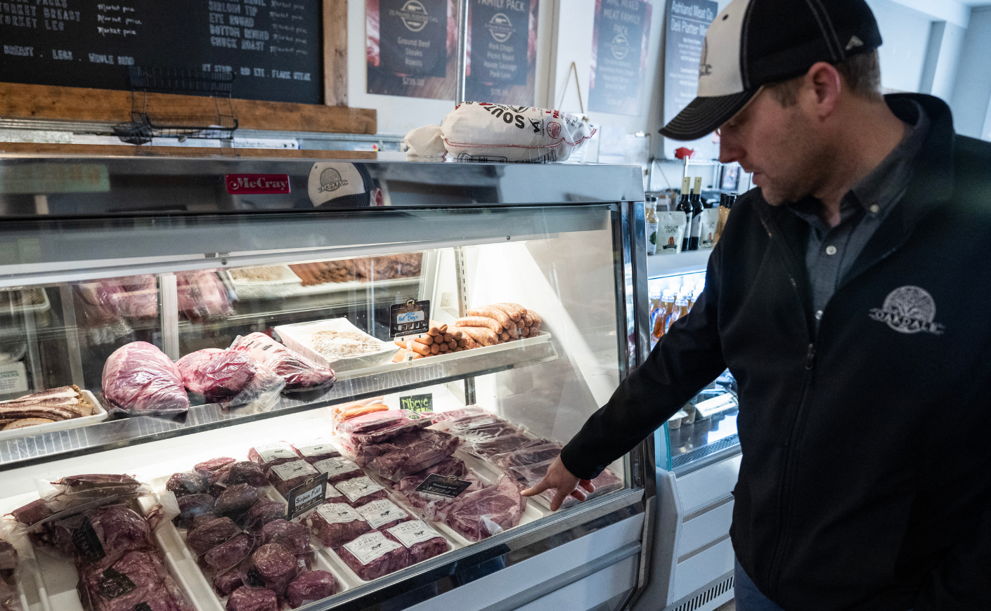 Chris Stem, 40, a cattle farmer on Oakland looks at beef for sale in a general store he owns in Ashland, Virginia