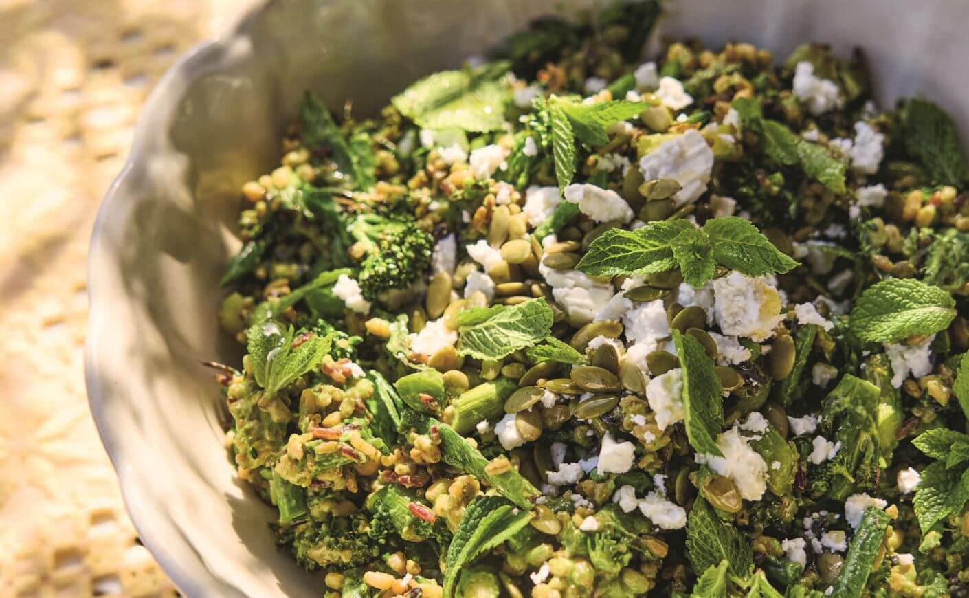 A bowl of green grain salad.