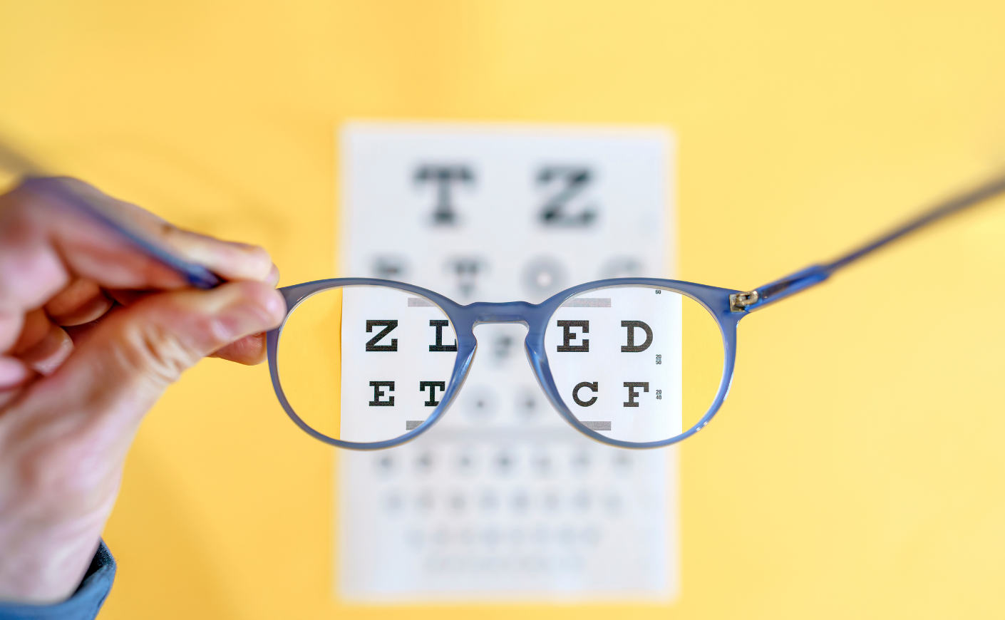 glasses in front of blurry eye chart