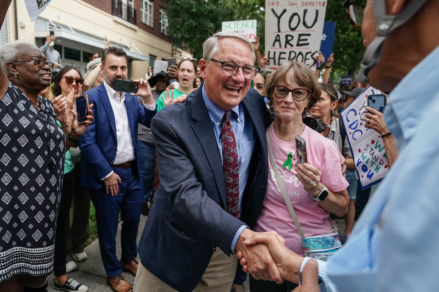 Former CDC official Daniel Jernigan greets a supporter.