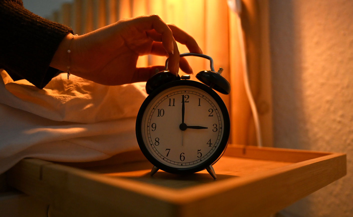close-up of woman changing her clock back