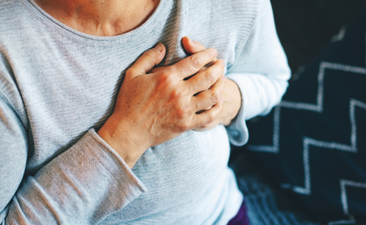 woman clutching her heart