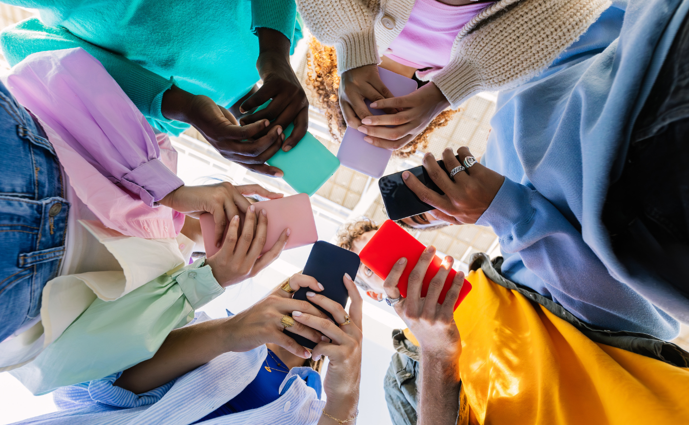 Teens in a circle on their phones