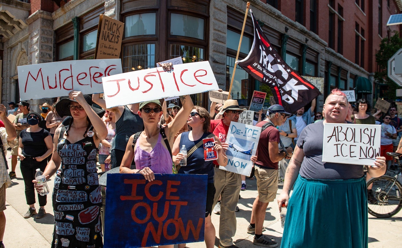 protestors in maine holding signs to abolish ice