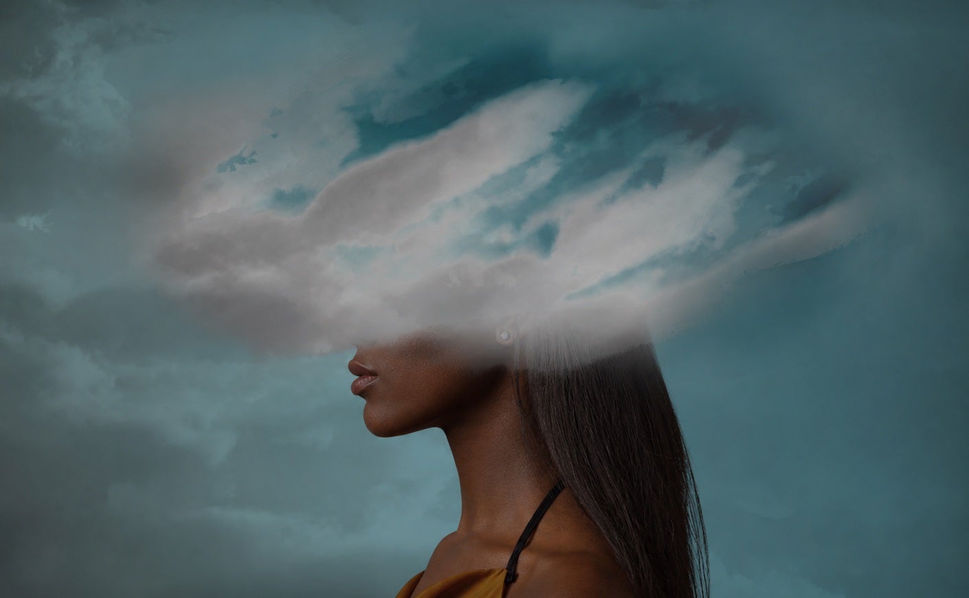 woman standing sideways with her head partially covered by a cloud