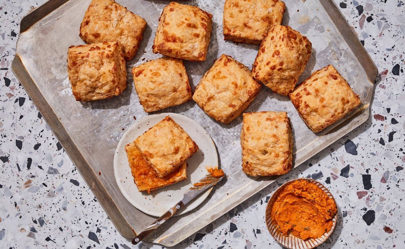 Kimchi asiago biscuits on a baking sheet.