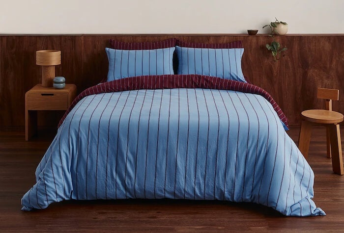 A bed with a duvet cover.