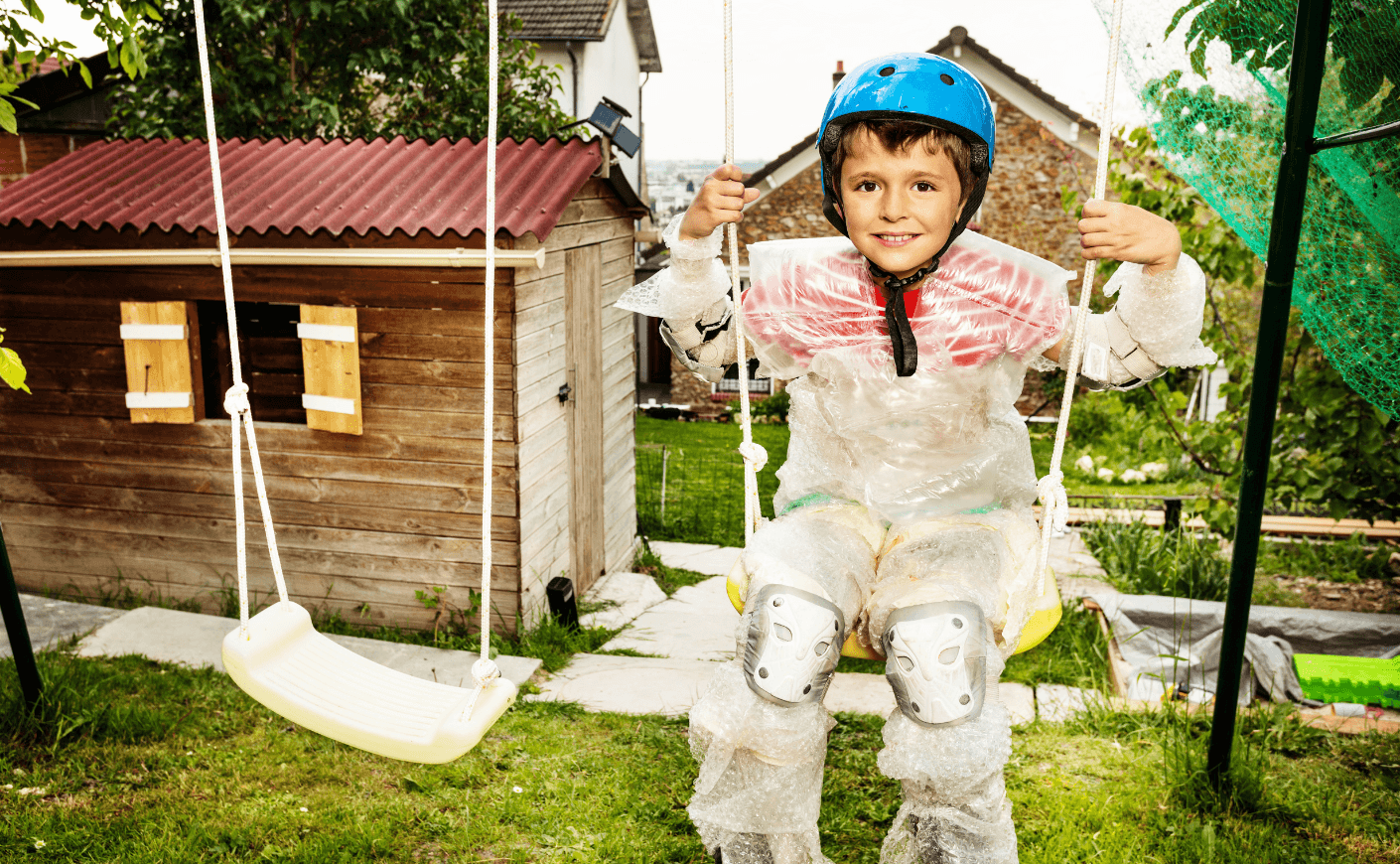 child on swings wrapped in bubblewrap