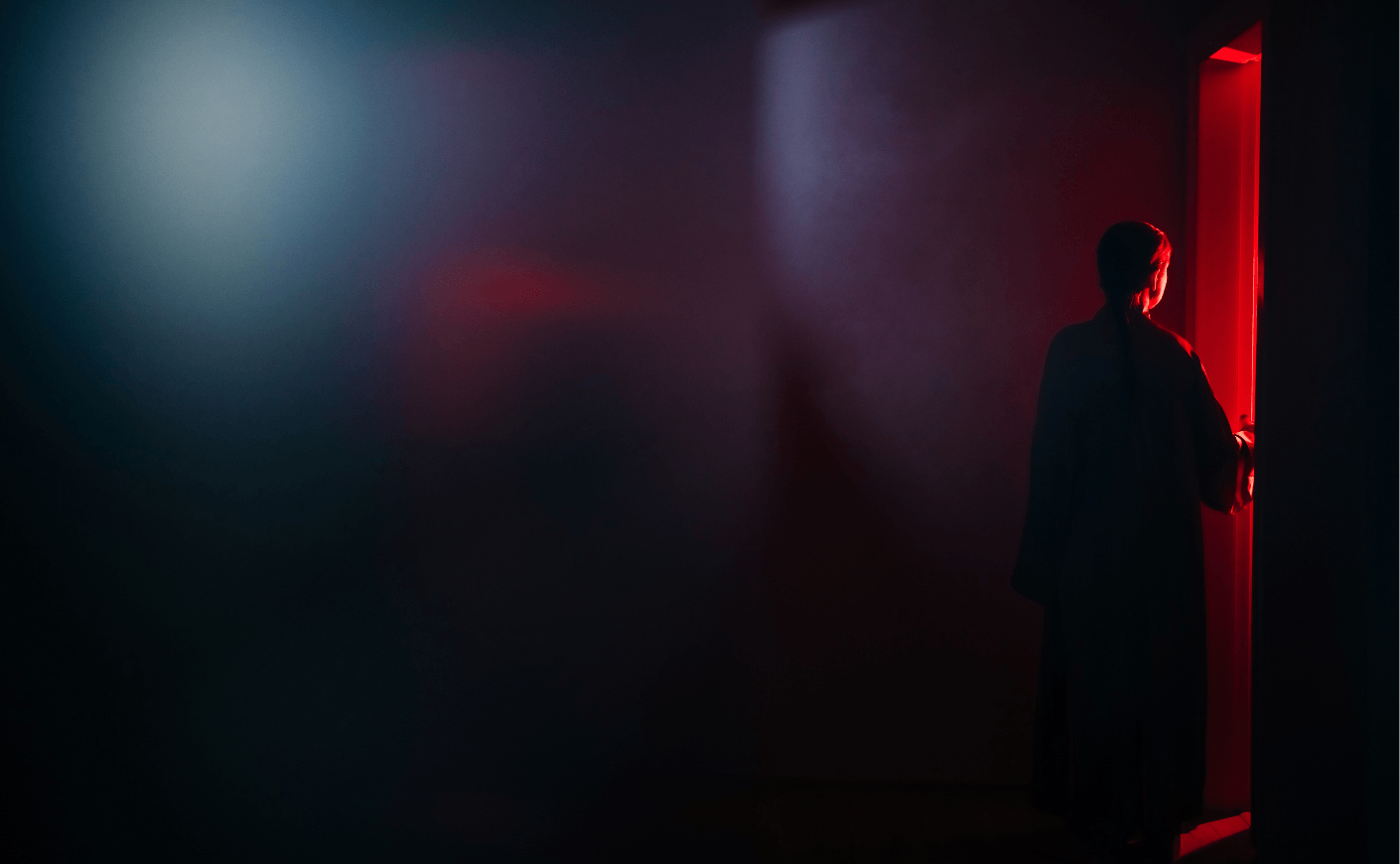 woman in dark room near door