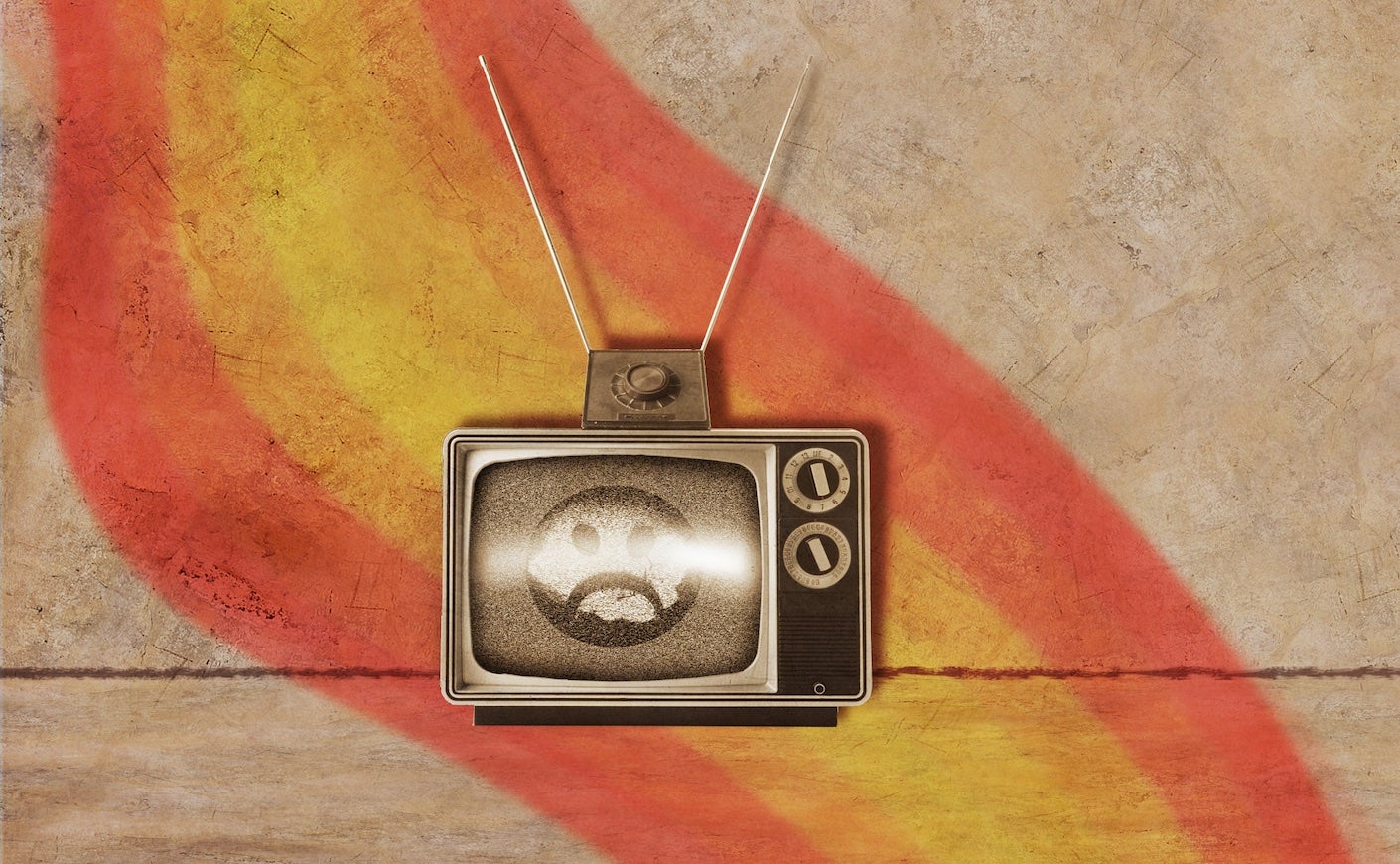 a tv with a sad emoji on the screen