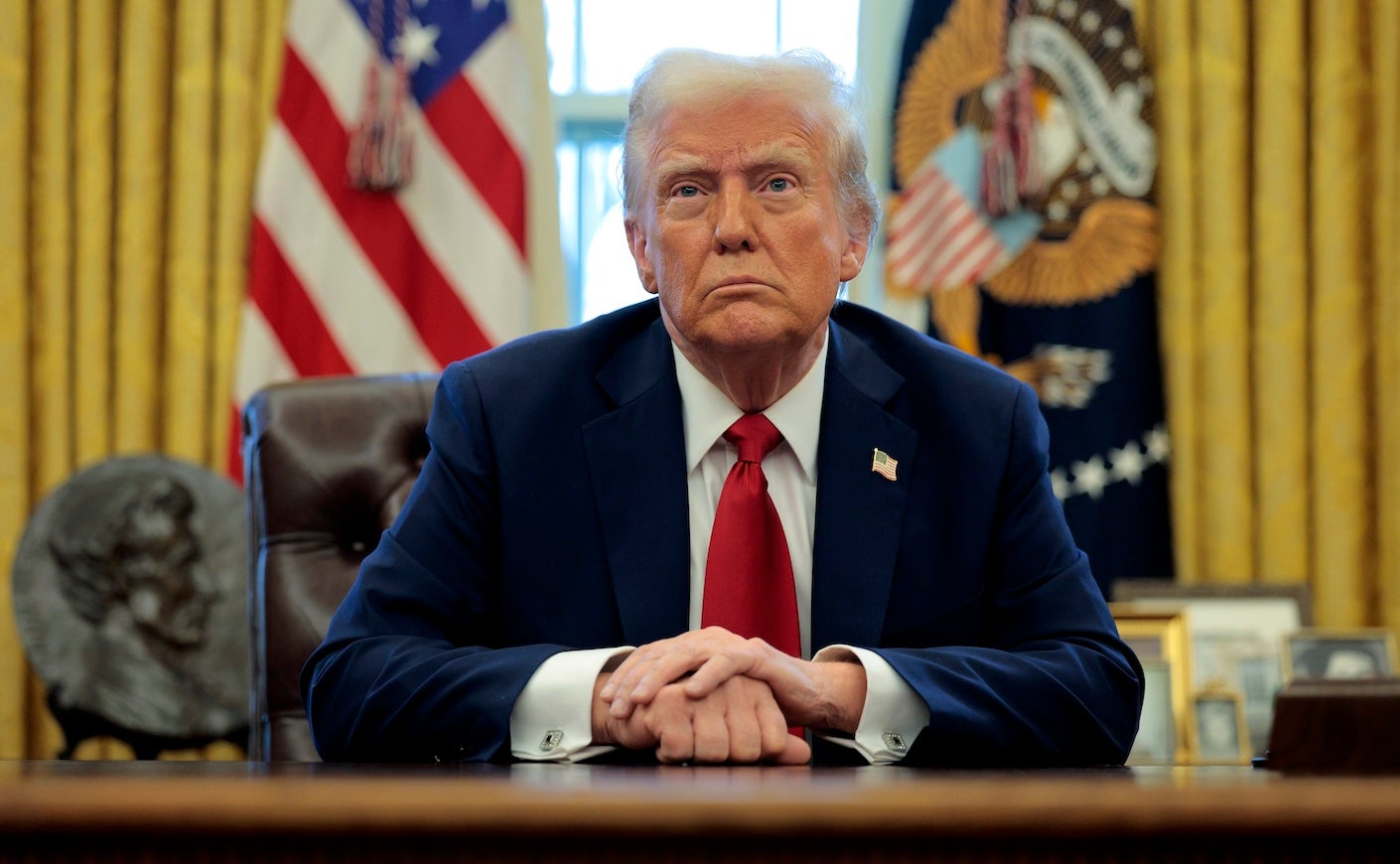 donald trump sitting at a desk