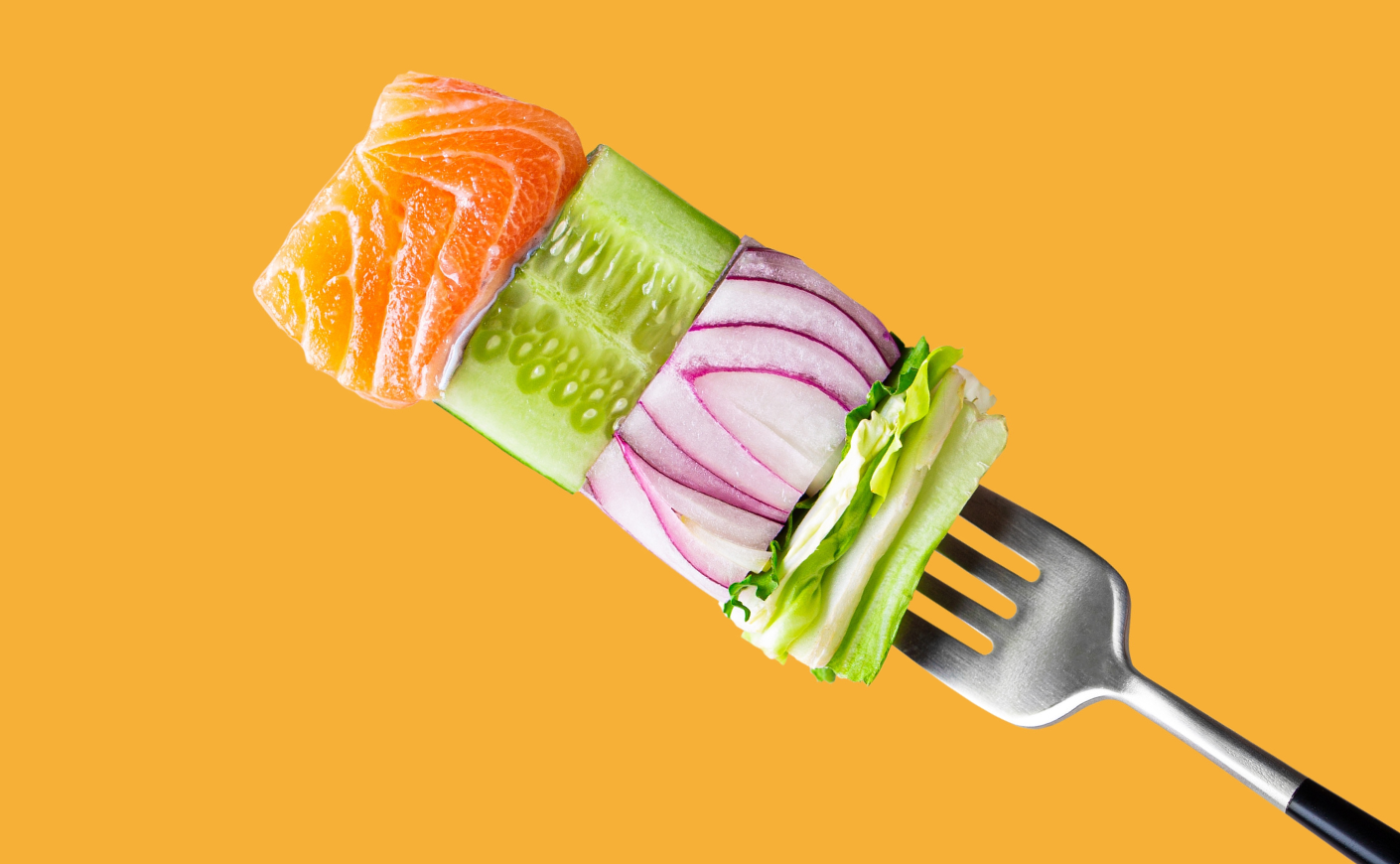 A fork with a small portion of fish and veggies on it