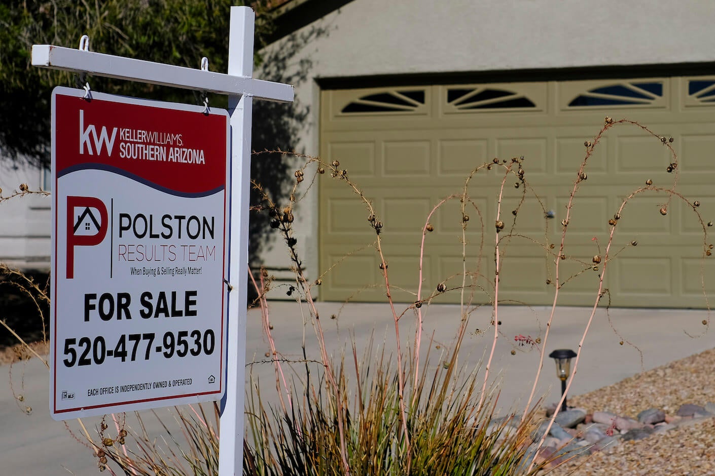 A for sale sign outside of a home.