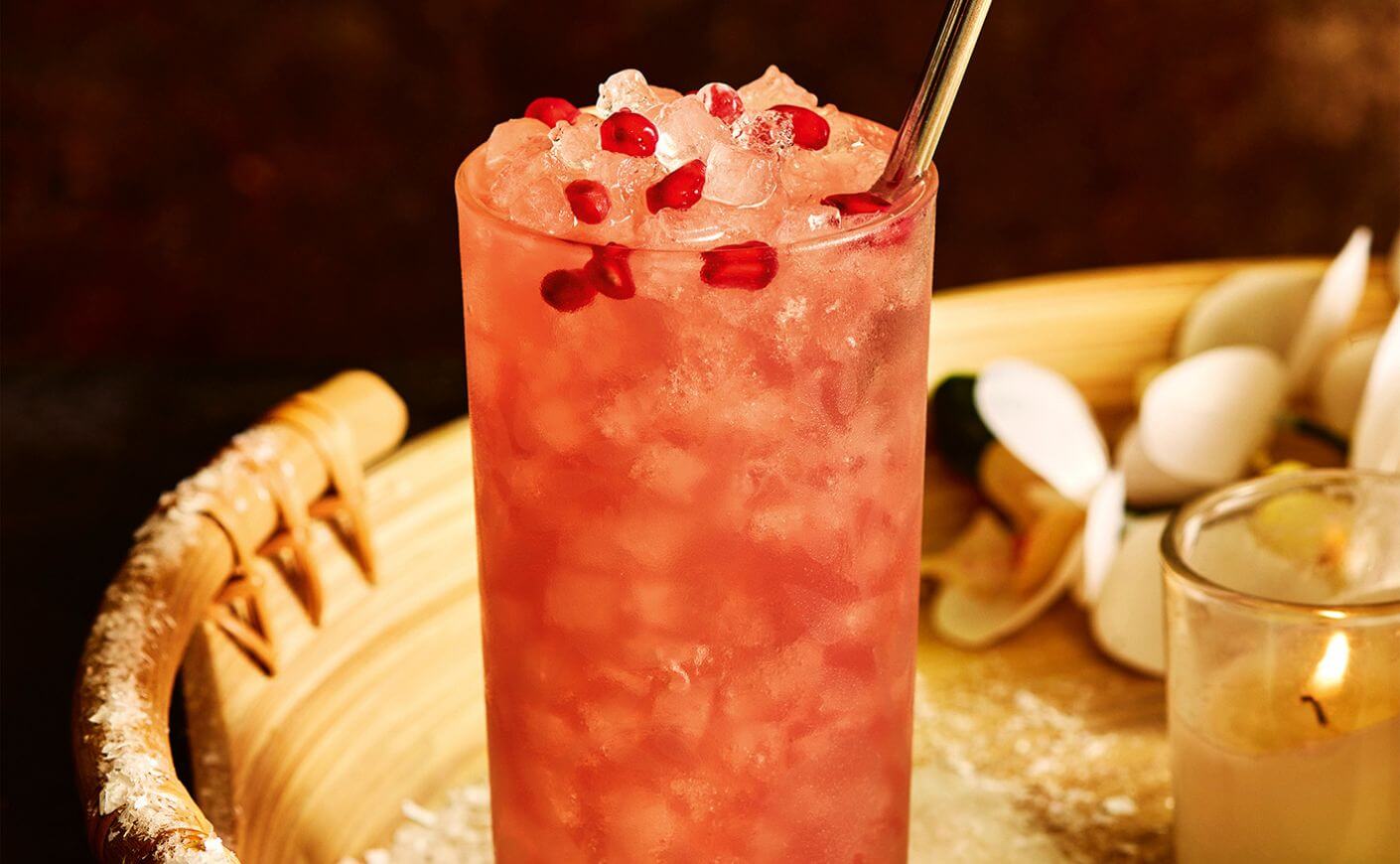 A ginger beer and tequila cocktail garnished with pomegranate seeds.