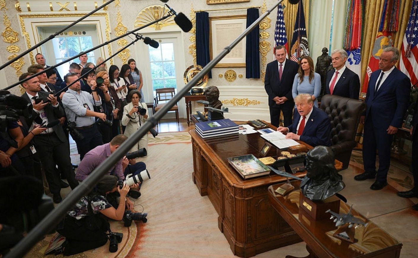 Trump with reporters in Oval Office.
