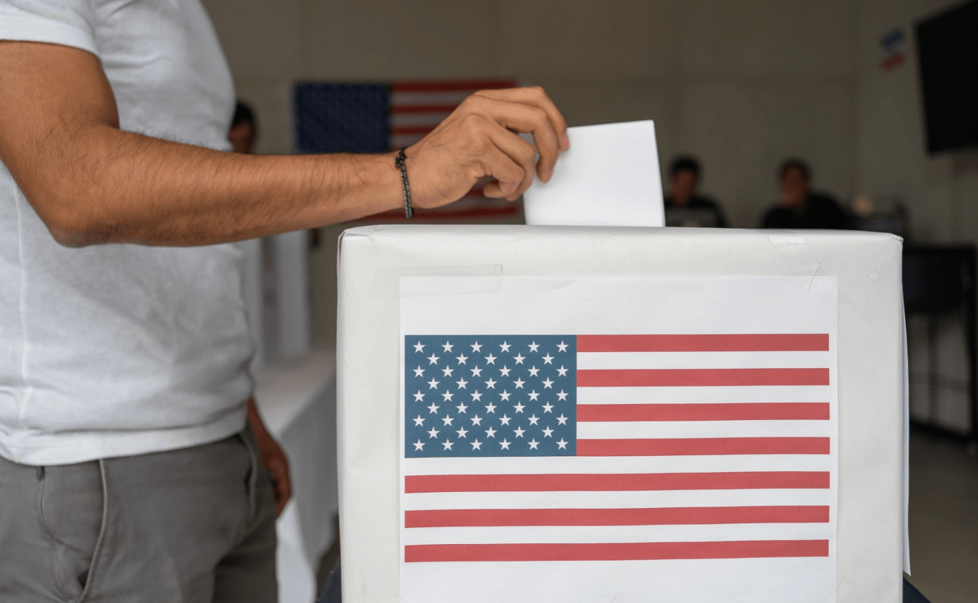 young man voting in ballot box