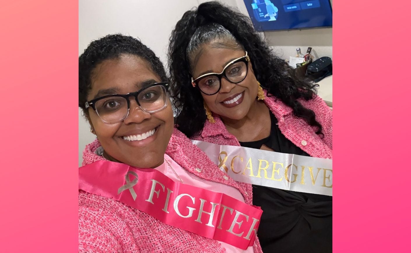 LaShae and Auby posing wearing breast cancer awareness sashes