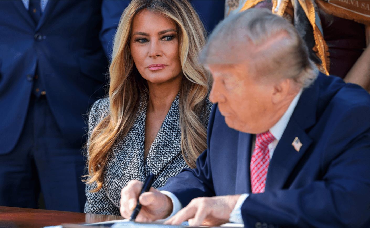 Melania Trump watching Donald Trump sign order