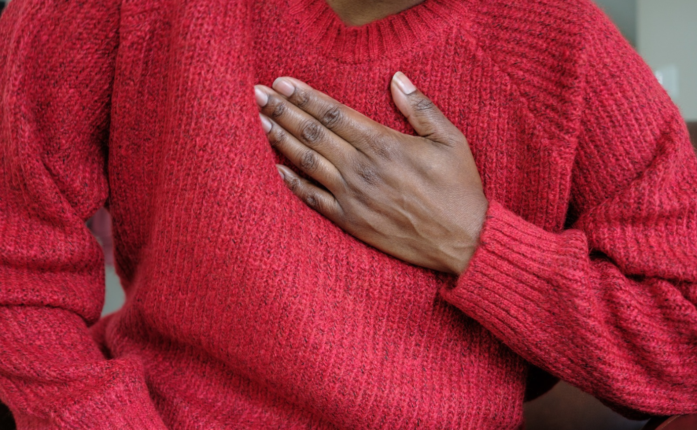 Black woman clutching her chest
