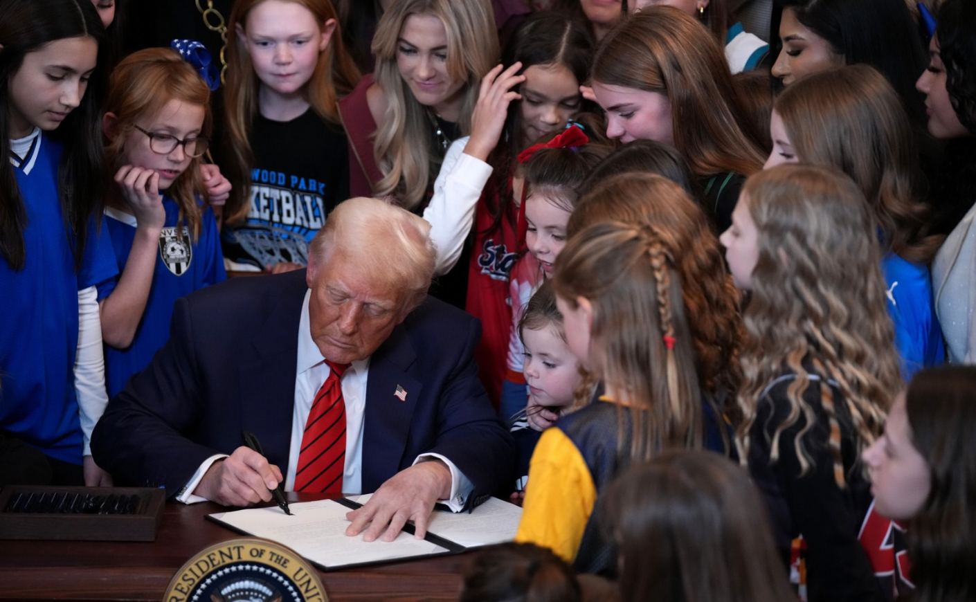 President Donald Trump signs an executive order barring transgender female athletes from competing in women’s or girls’ sporting events, on Feb. 5, 2025. 