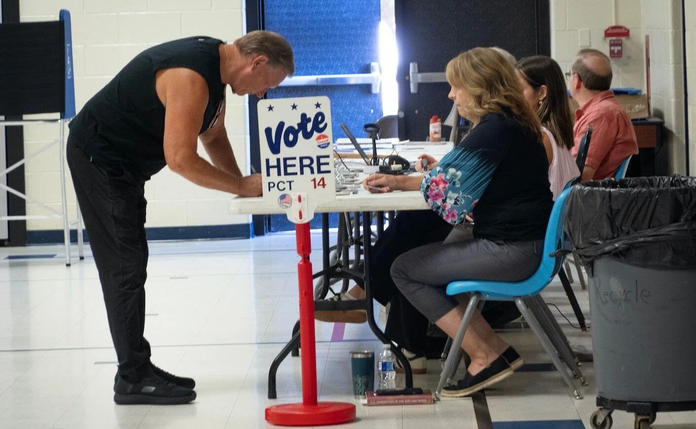 Residents check in to vote in the primary at a polling place at Morgan Elementary School on Aug. 4, 2026.